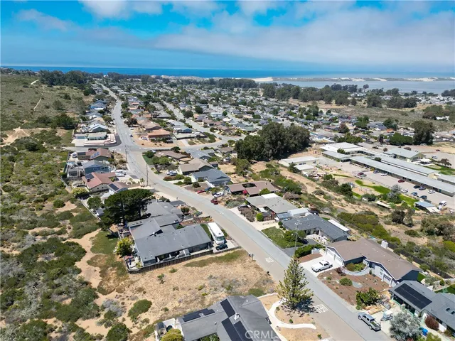 an aerial view of residential house and sandy dunes