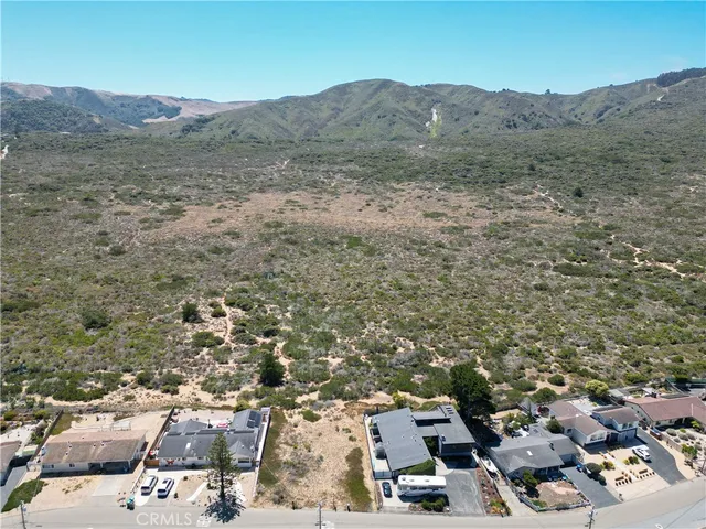 an aerial view of residential houses with city view