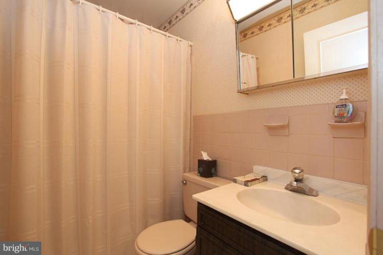 9518 Clement Road Silver Spring, MD 20910 - Photo 2 of 27 a bathroom with a sink and a mirror