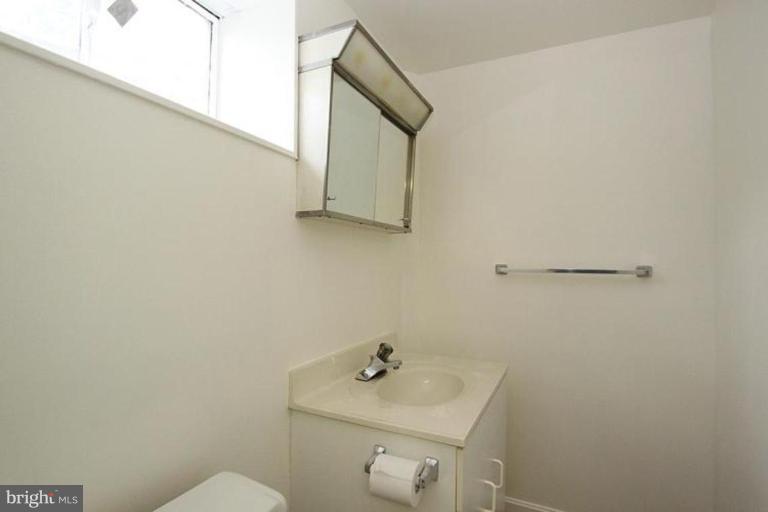 9518 Clement Road Silver Spring, MD 20910 - Photo 15 of 27 a bathroom with a sink a mirror and vanity