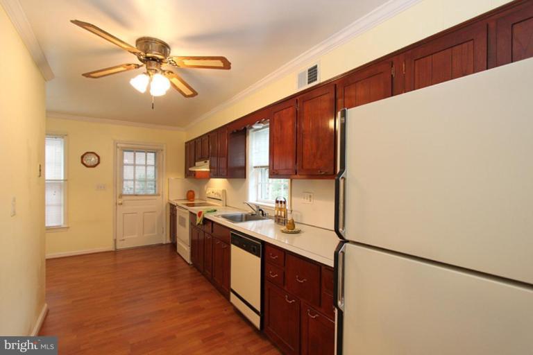 9518 Clement Road Silver Spring, MD 20910 - Photo 16 of 27 a kitchen with stainless steel appliances a sink a refrigerator and cabinets