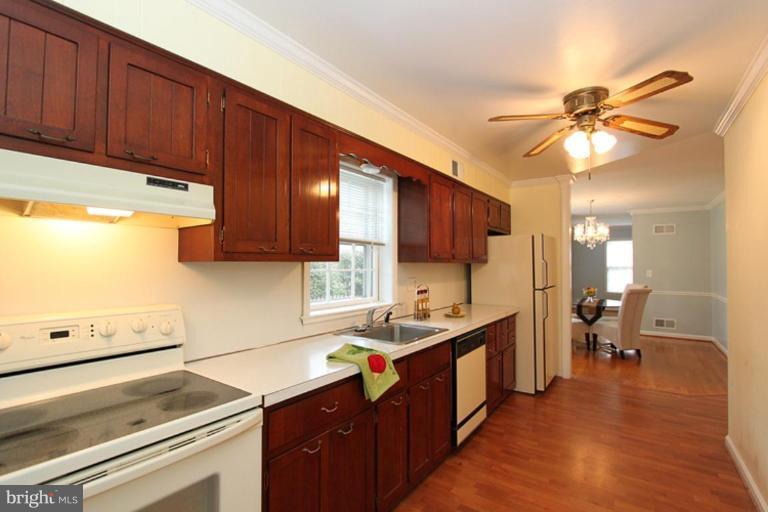 9518 Clement Road Silver Spring, MD 20910 - Photo 17 of 27 a kitchen with a sink cabinets and window