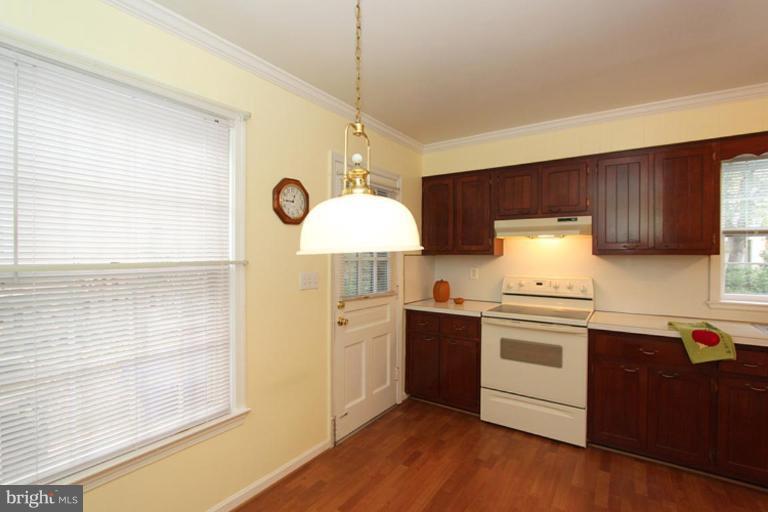 9518 Clement Road Silver Spring, MD 20910 - Photo 18 of 27 a kitchen with granite countertop a stove a sink and a refrigerator