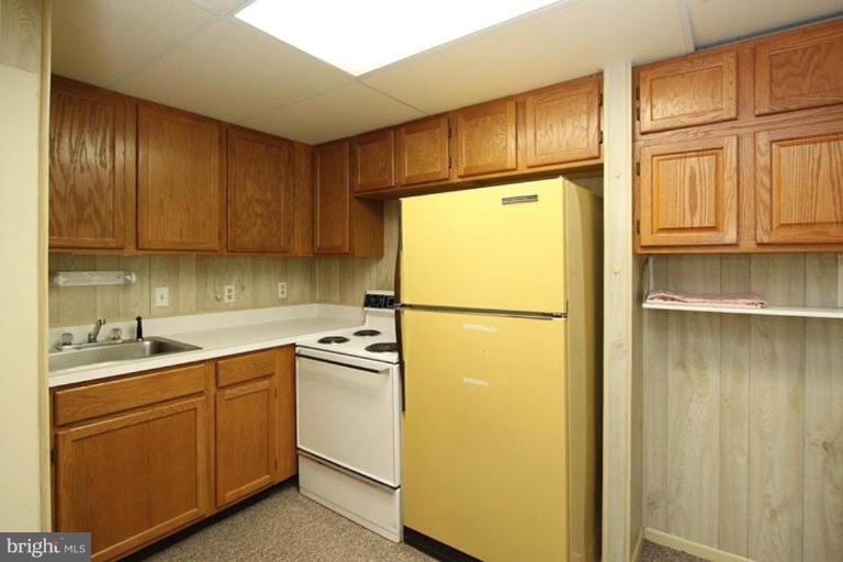 9518 Clement Road Silver Spring, MD 20910 - Photo 19 of 27 a kitchen with a refrigerator sink and cabinets