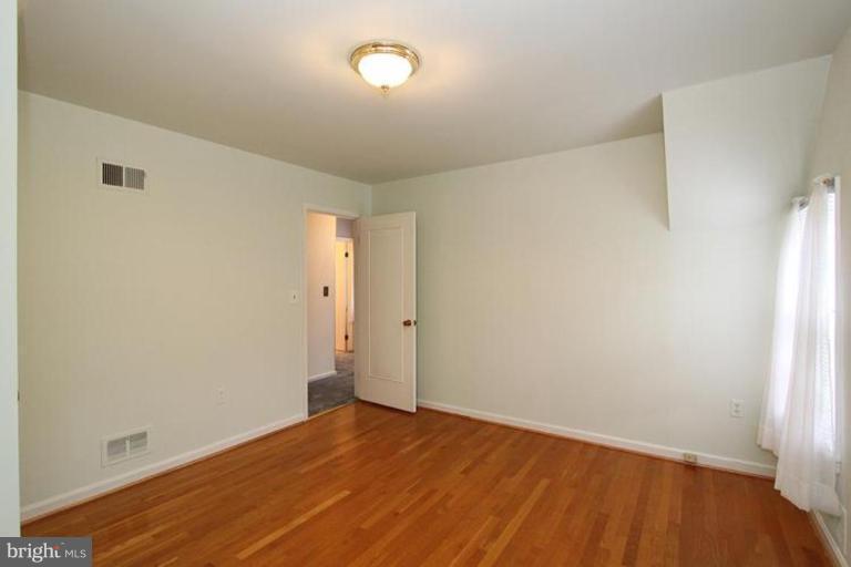 9518 Clement Road Silver Spring, MD 20910 - Photo 7 of 27 a view of an empty room with wooden floor