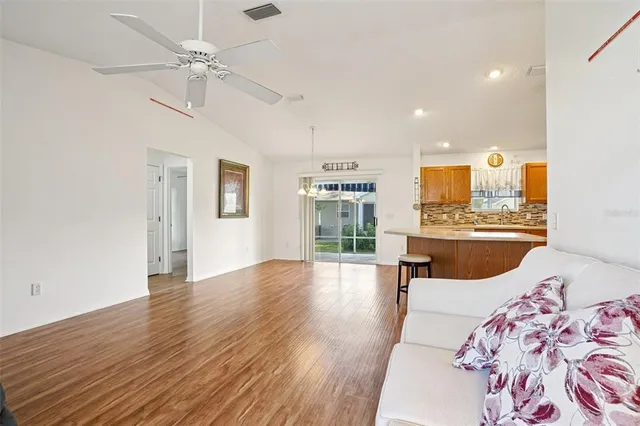 a living room with furniture and kitchen view