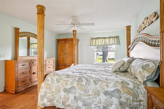a bedroom with a bed and dresser with mirror