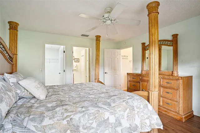 a bedroom with a bed and dresser with mirror