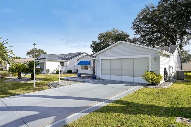 a front view of a house with a yard garage and outdoor seating