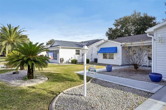 a house view with a sitting space and garden