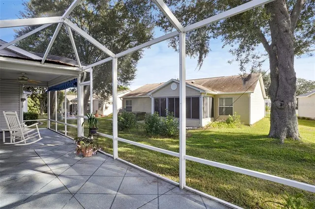 a view of a house with backyard and porch
