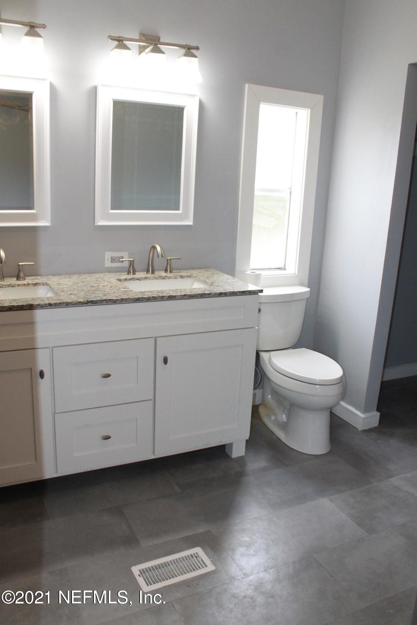 16006 Shellcracker Road Jacksonville, FL 32226 - Photo 21 of 41 a bathroom with a granite countertop toilet a sink and a mirror