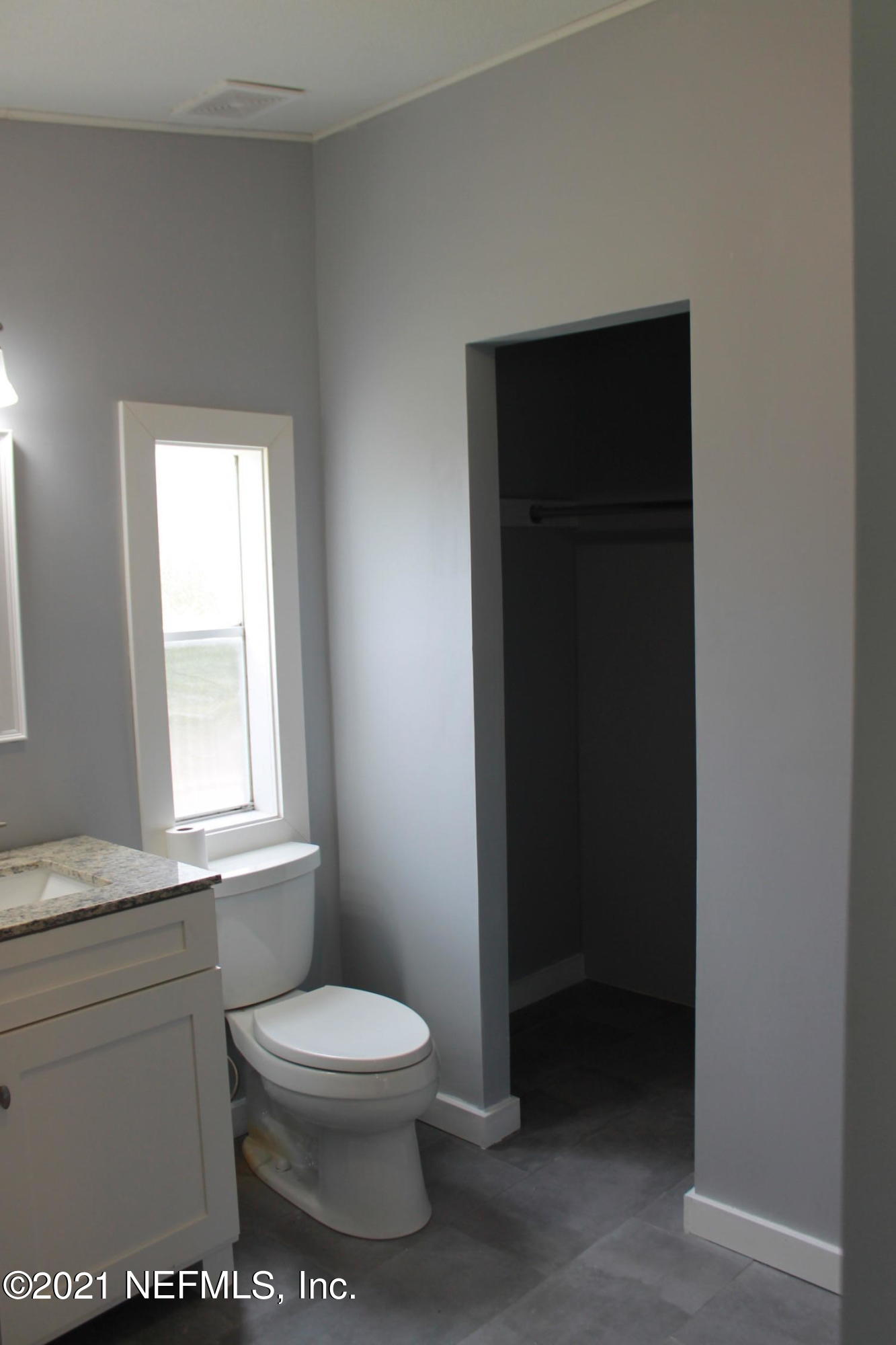 16006 Shellcracker Road Jacksonville, FL 32226 - Photo 22 of 41 a bathroom with a toilet a sink a window and vanity