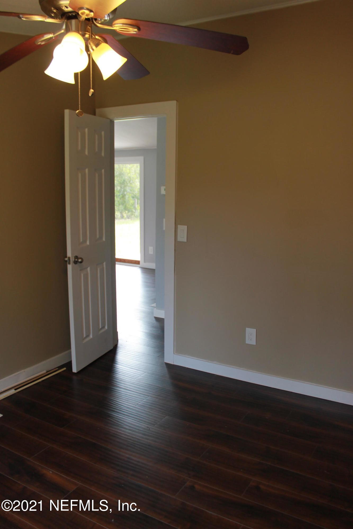 16006 Shellcracker Road Jacksonville, FL 32226 - Photo 27 of 41 a view of empty room with wooden floor and fan