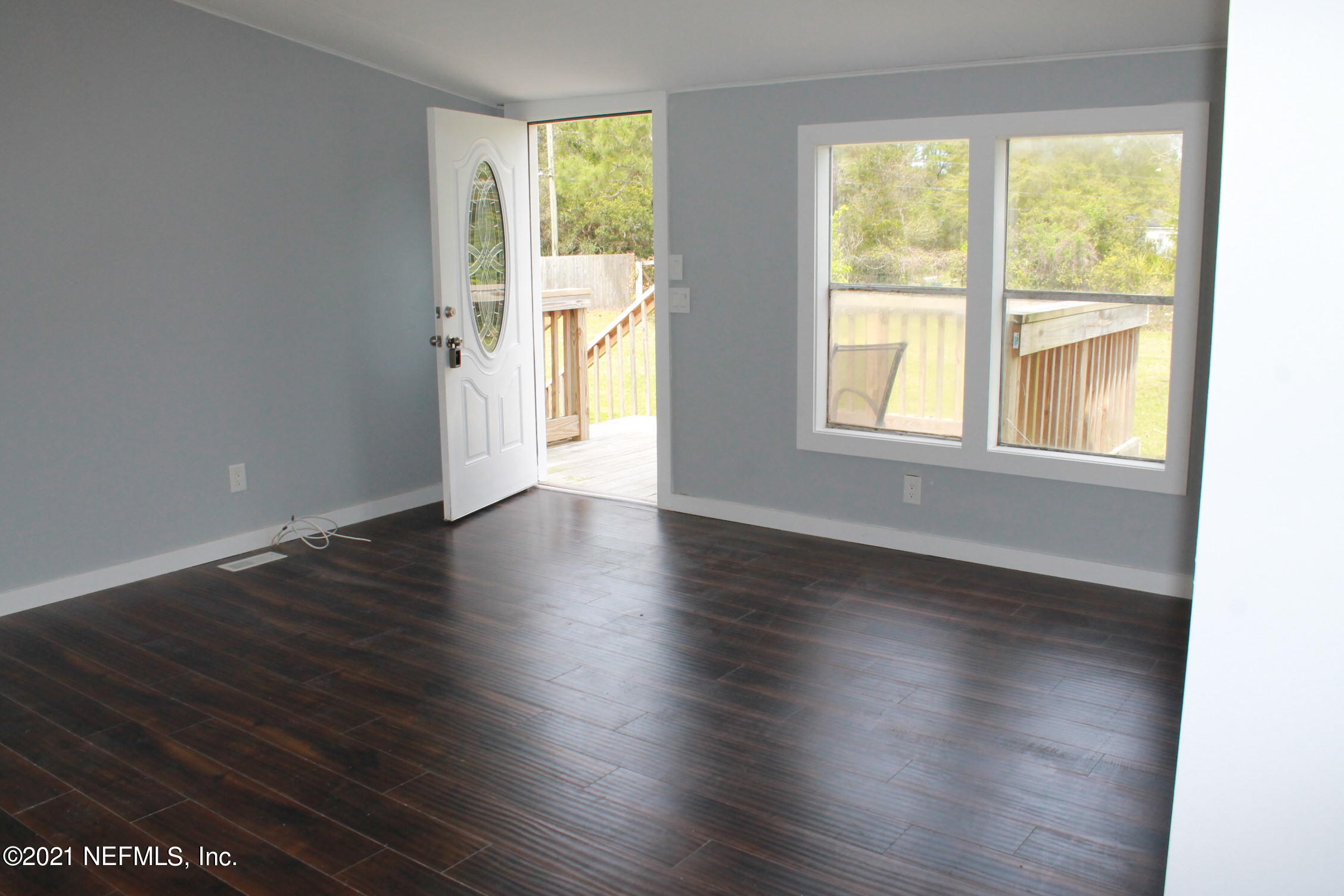 16006 Shellcracker Road Jacksonville, FL 32226 - Photo 4 of 41 an empty room with wooden floor and windows