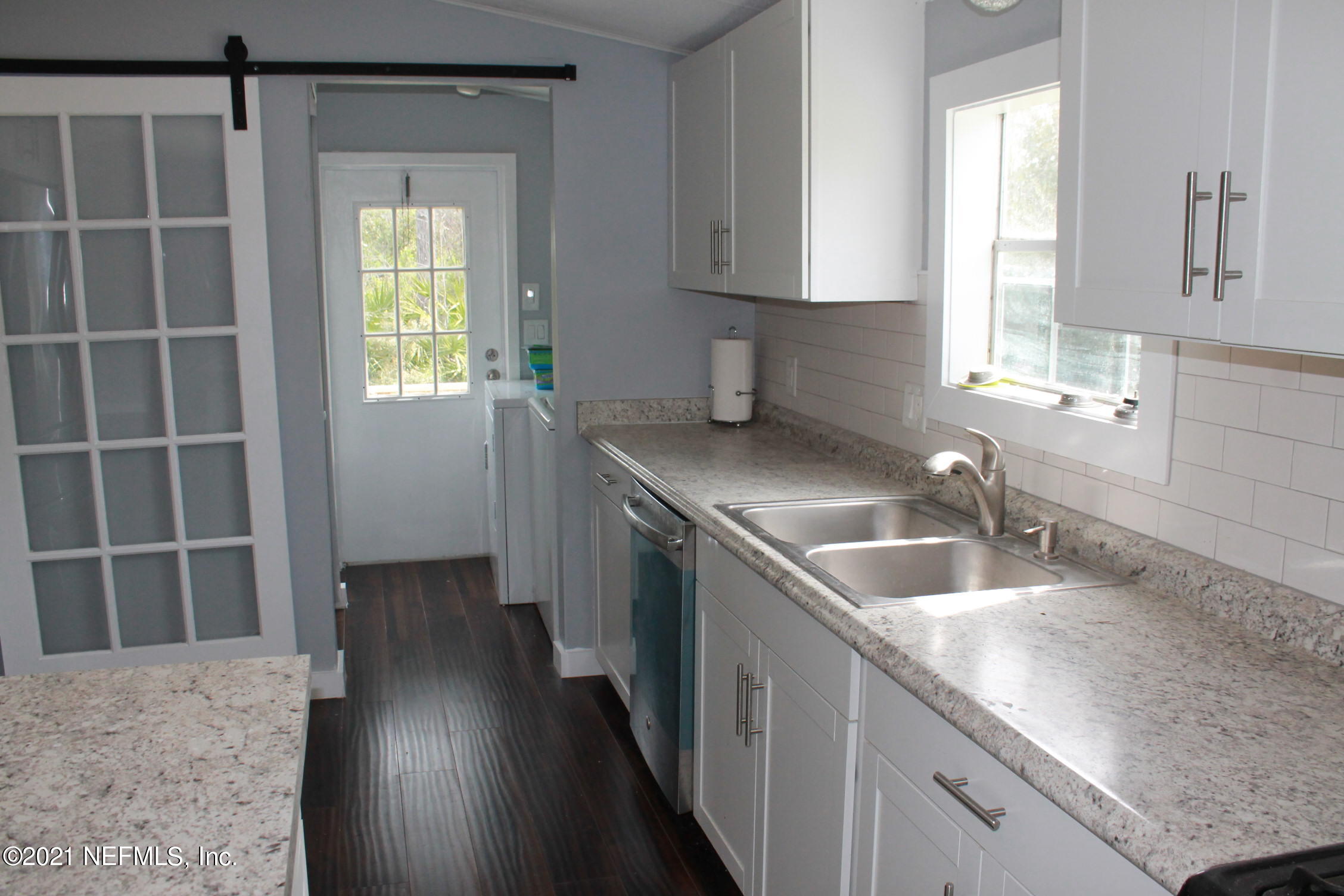 16006 Shellcracker Road Jacksonville, FL 32226 - Photo 6 of 41 a kitchen with a sink stove and cabinets