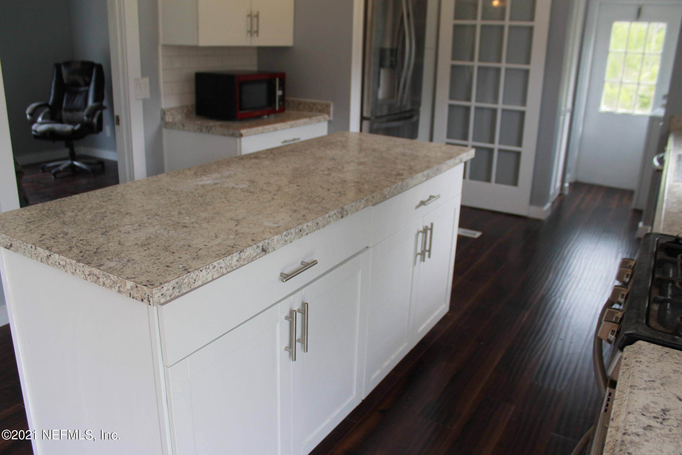 16006 Shellcracker Road Jacksonville, FL 32226 - Photo 7 of 41 a kitchen with a stove and a wooden floor