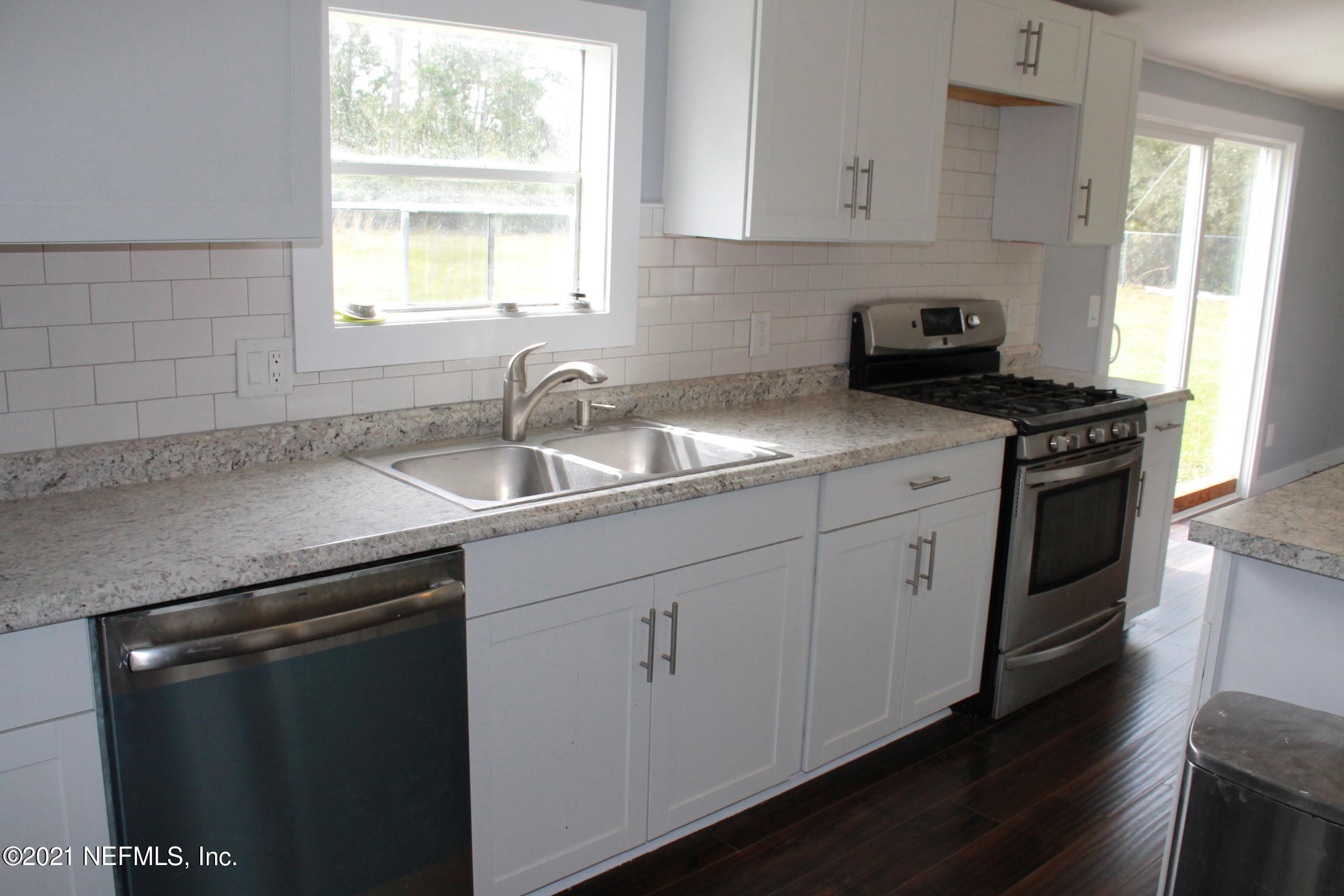16006 Shellcracker Road Jacksonville, FL 32226 - Photo 9 of 41 a kitchen with a sink stove and cabinets
