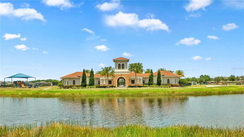 16636 Windmill Forge Pass Wimauma, FL 33598 - Photo 14 of 51 a view of a lake with a house in the background