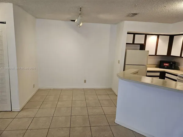 a view of a room with a sink and cabinets