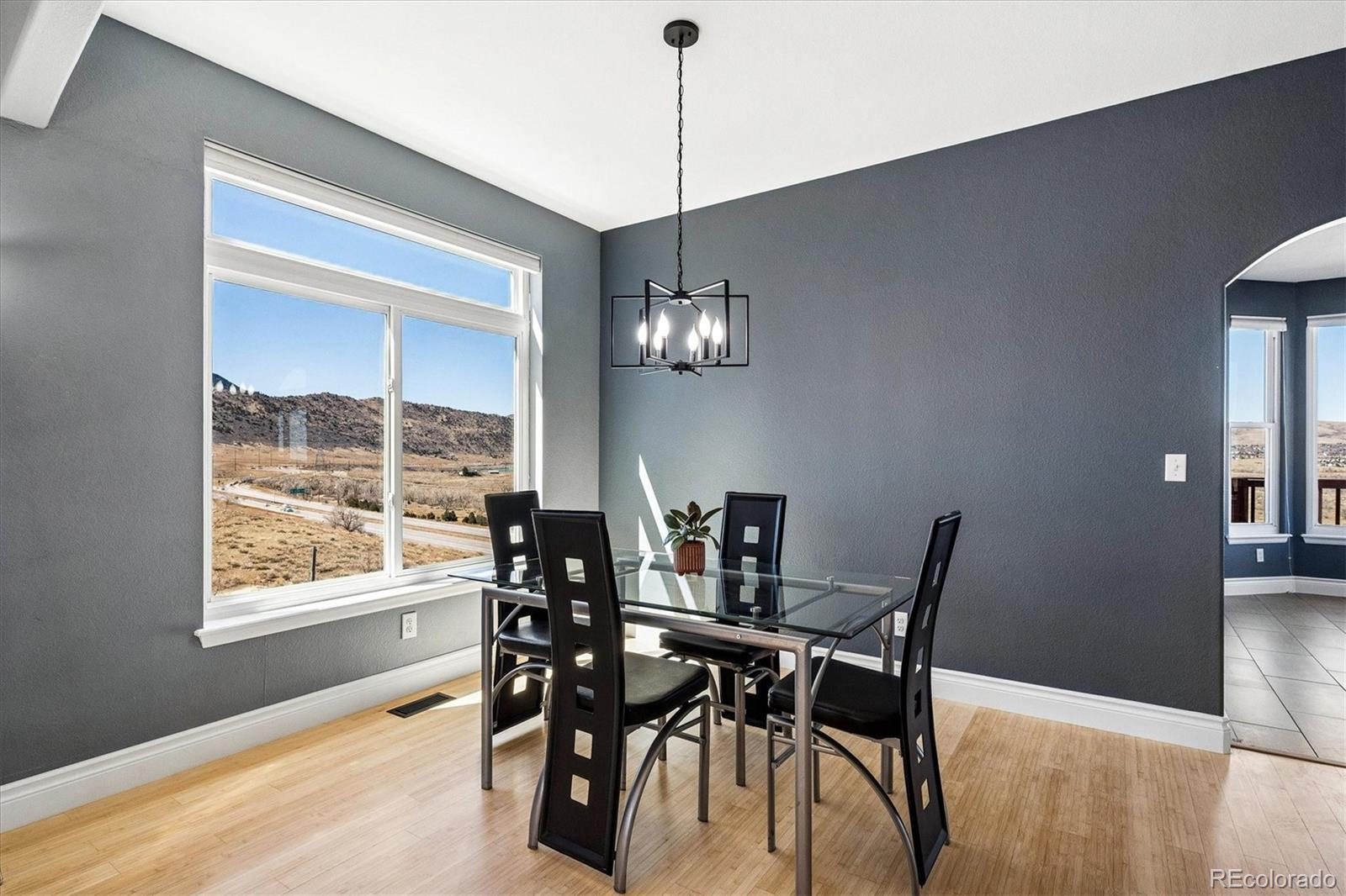 4143 South Deframe Court Morrison, CO 80465 - Photo 16 of 48 a view of a dining room with furniture window and wooden floor