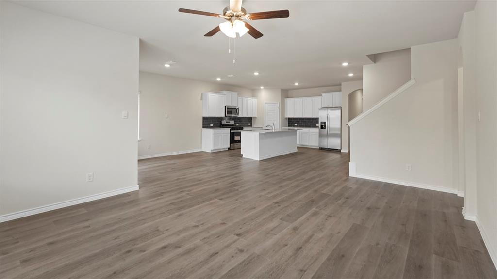 447 Epiphany Lane Lavon, TX 75166 - Photo 12 of 31 Open-concept living space featuring wood-finish flooring, recessed lighting, and a ceiling fan