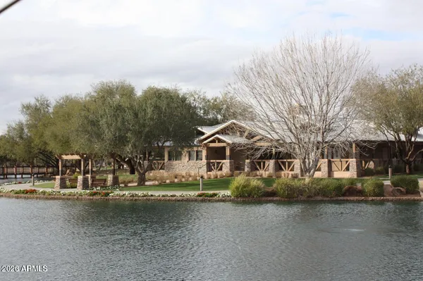a front view of a house with a yard and fountain in middle