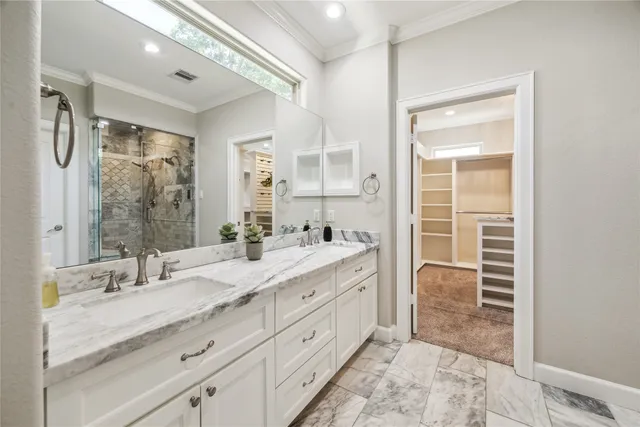 a spacious bathroom with a double vanity sink a mirror and a shower
