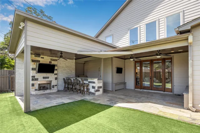 a view of a chair and table in backyard of the house