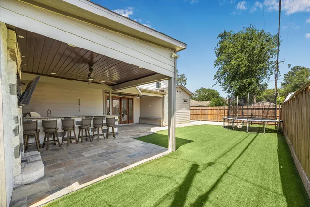 a view of a backyard with sitting area