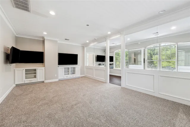 a view of an empty room with a kitchen