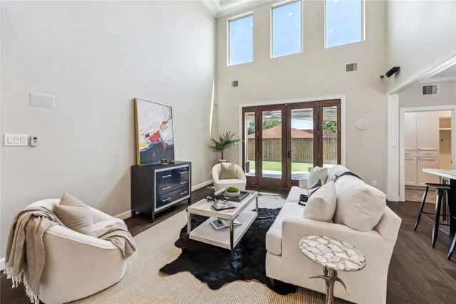 a living room with furniture and a floor to ceiling window