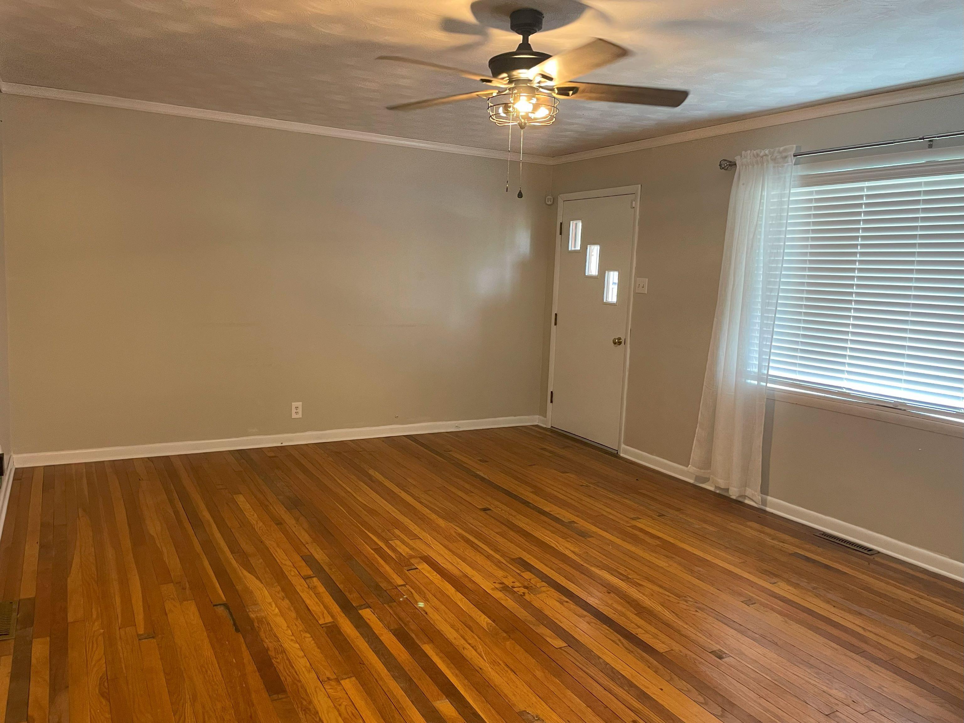 5636 Conner Whitefield Road Ripley, TN 38063 - Photo 3 of 11 wooden floor in an empty room with a window