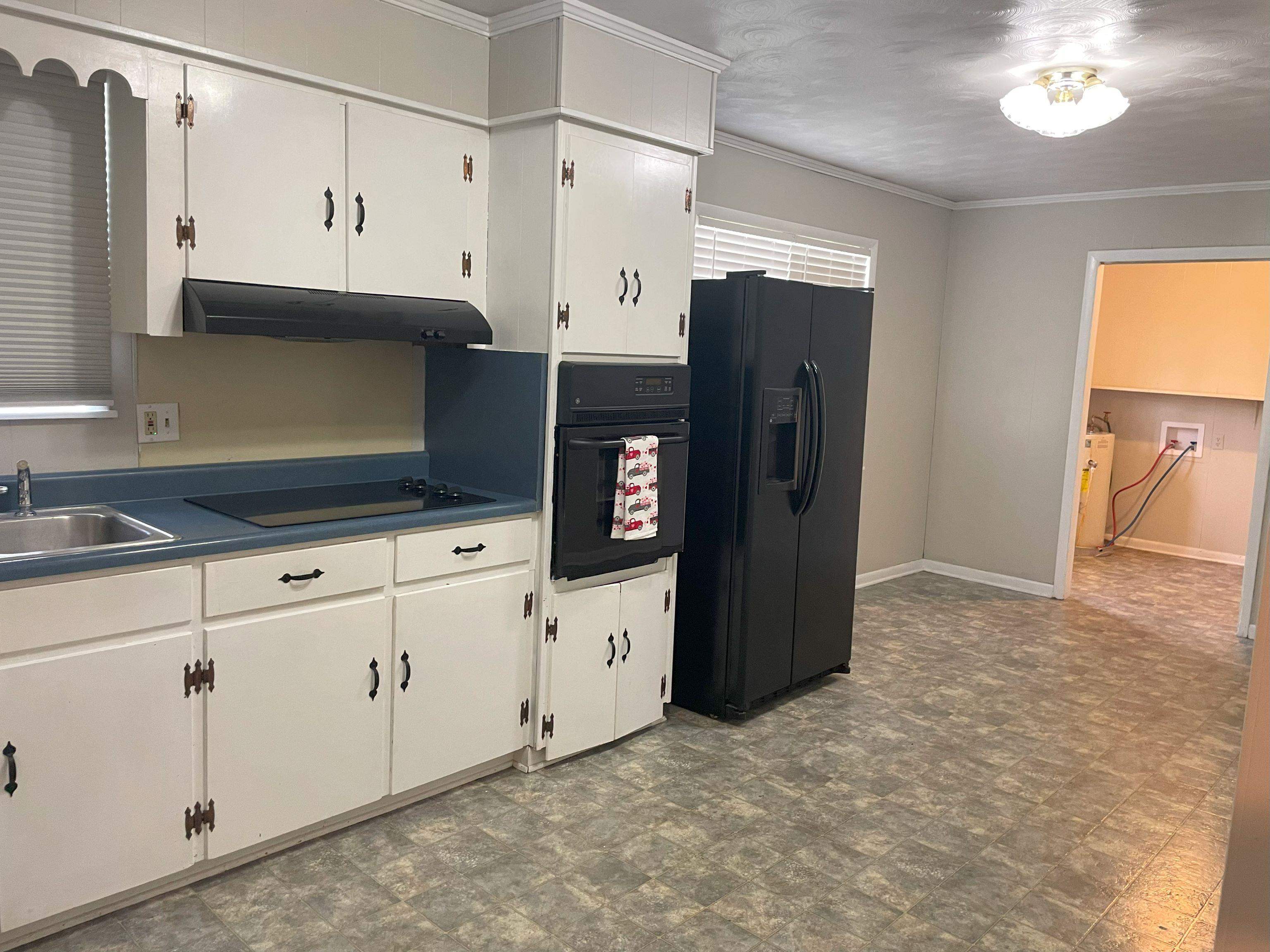 5636 Conner Whitefield Road Ripley, TN 38063 - Photo 5 of 11 a kitchen with stainless steel appliances granite countertop a refrigerator and a stove top oven