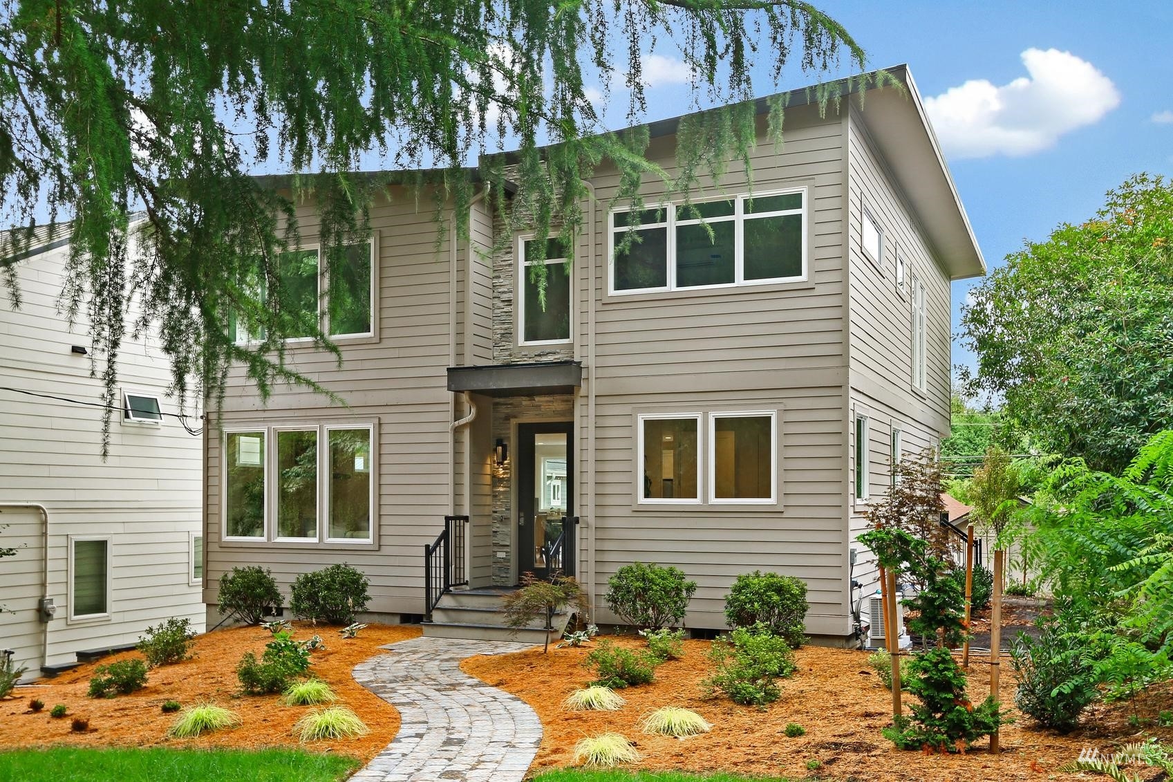 a house that has a tree in front of the house