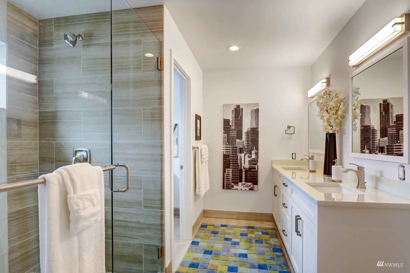 3838 36th Avenue West Seattle, WA 98199 - Photo 17 of 24 a bathroom with a double vanity sink a mirror and shower