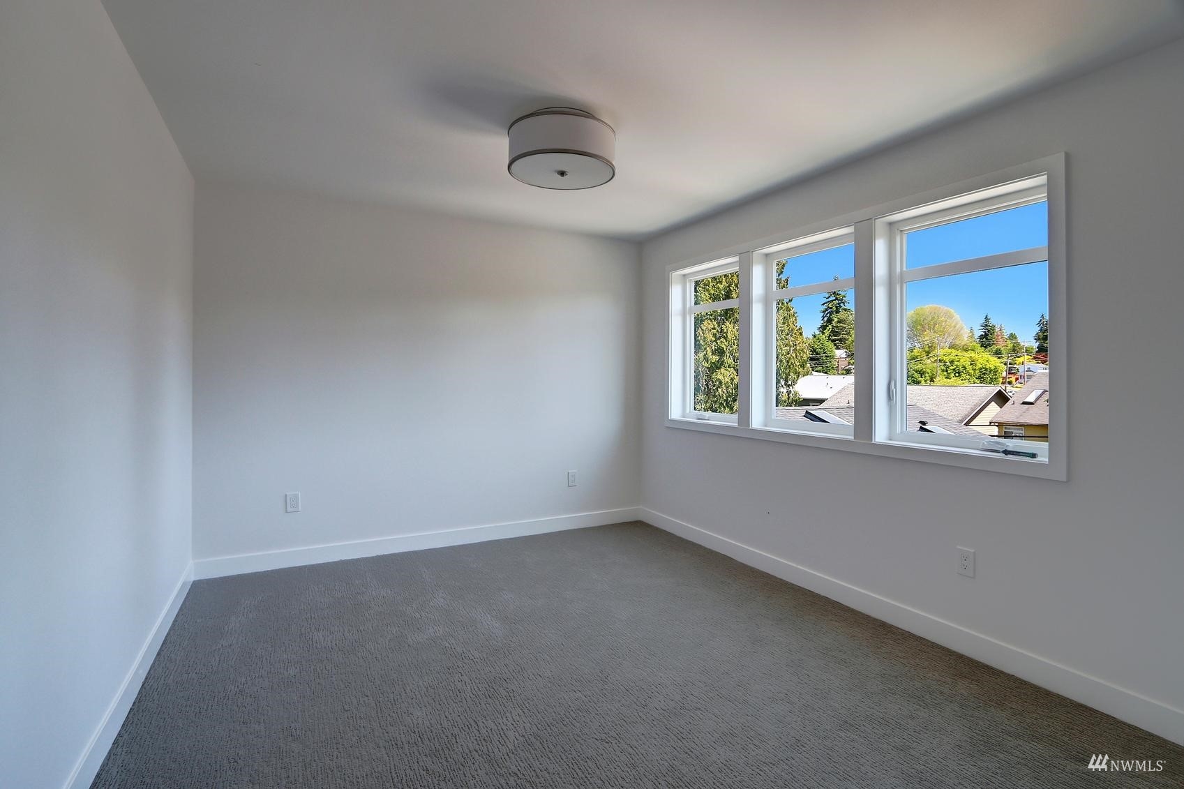 3838 36th Avenue West Seattle, WA 98199 - Photo 19 of 24 an empty room with windows and view