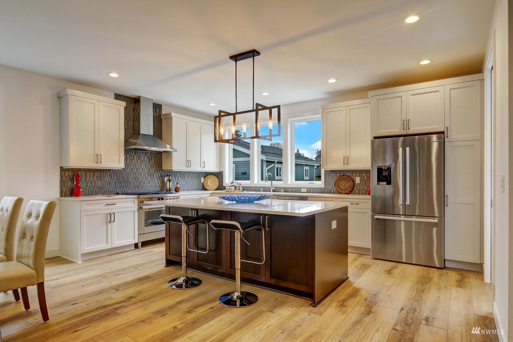 3838 36th Avenue West Seattle, WA 98199 - Photo 2 of 24 a kitchen with kitchen island granite countertop a sink appliances and cabinets