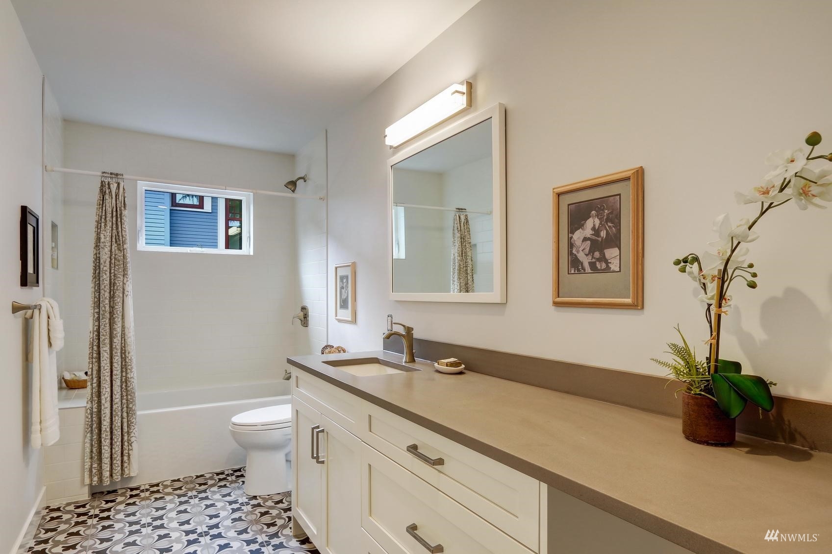 3838 36th Avenue West Seattle, WA 98199 - Photo 21 of 24 a bathroom with a granite countertop sink a toilet and a shower