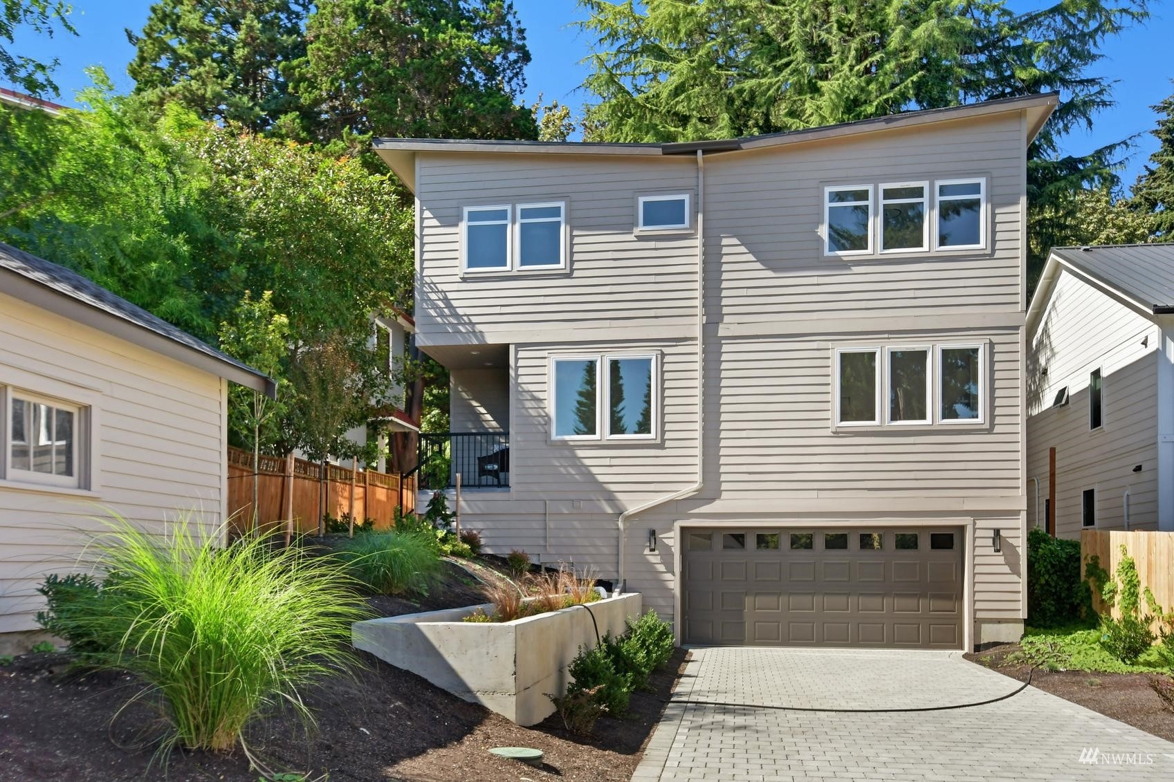 3838 36th Avenue West Seattle, WA 98199 - Photo 24 of 24 a front view of a house with a yard and garage