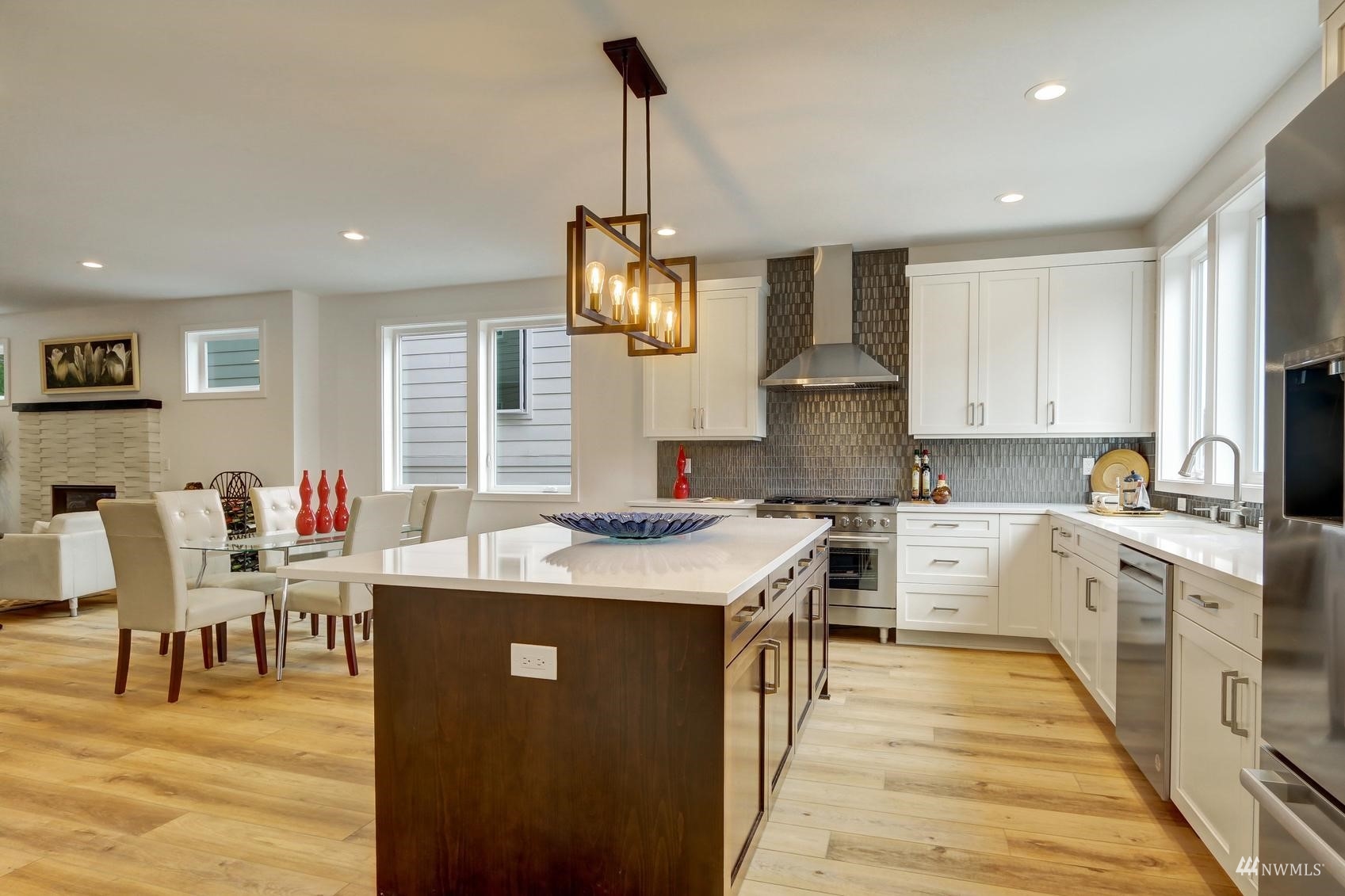 3838 36th Avenue West Seattle, WA 98199 - Photo 4 of 24 a kitchen that has a lot of cabinets in it and wooden floors