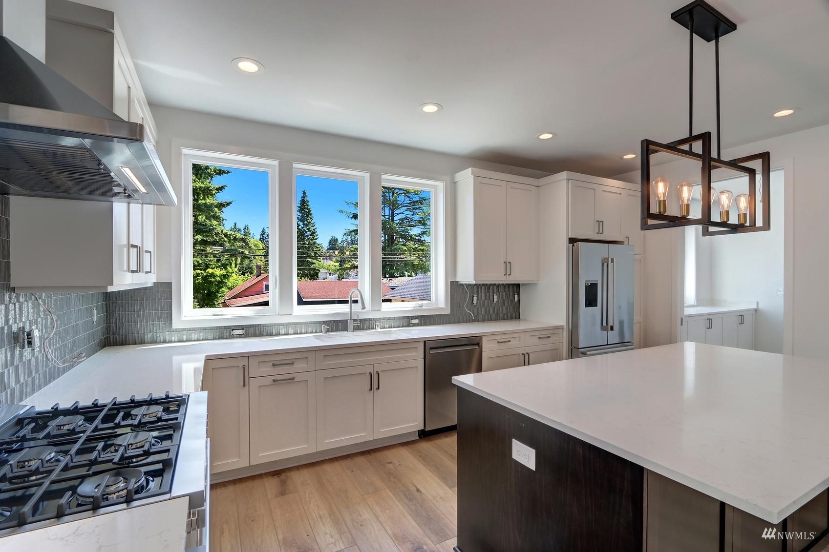 3838 36th Avenue West Seattle, WA 98199 - Photo 5 of 24 a kitchen with a sink stove and refrigerator