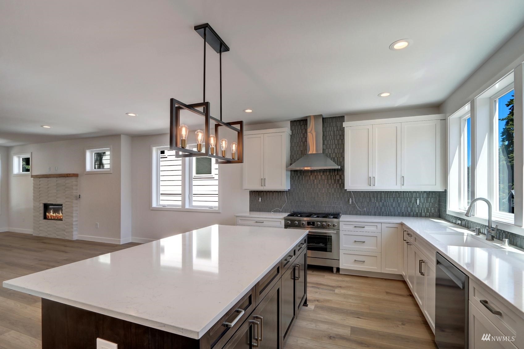 3838 36th Avenue West Seattle, WA 98199 - Photo 6 of 24 a kitchen with kitchen island a wooden floor and white appliances