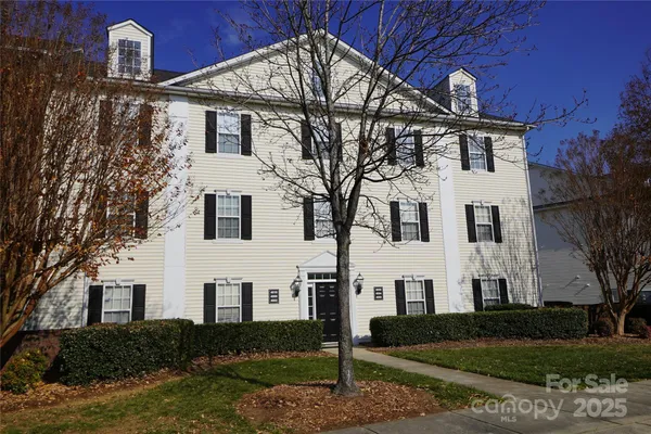 a view of white house with a yard