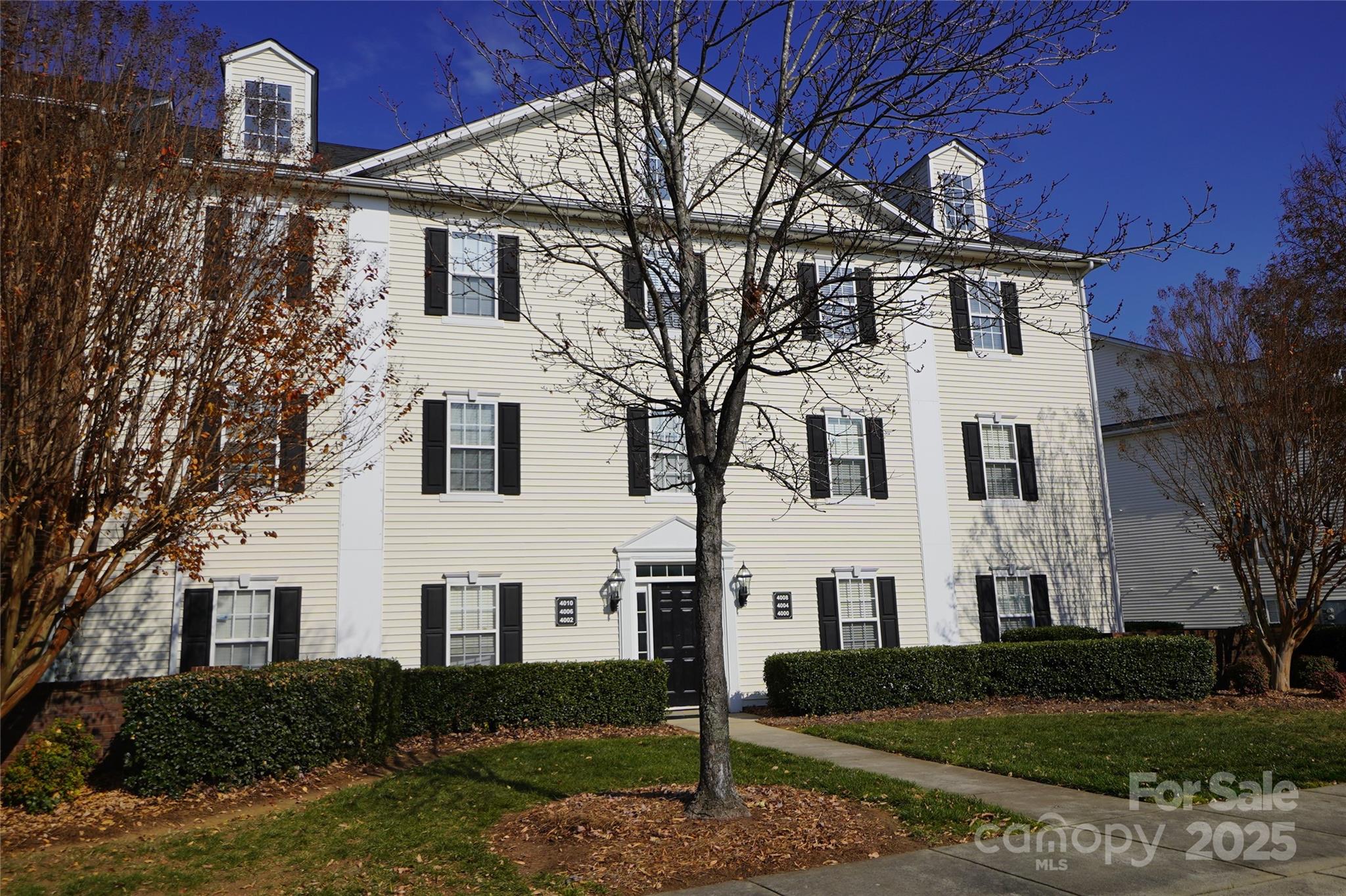 a view of white house with a yard