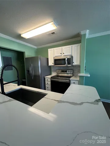 a kitchen with a refrigerator and a sink