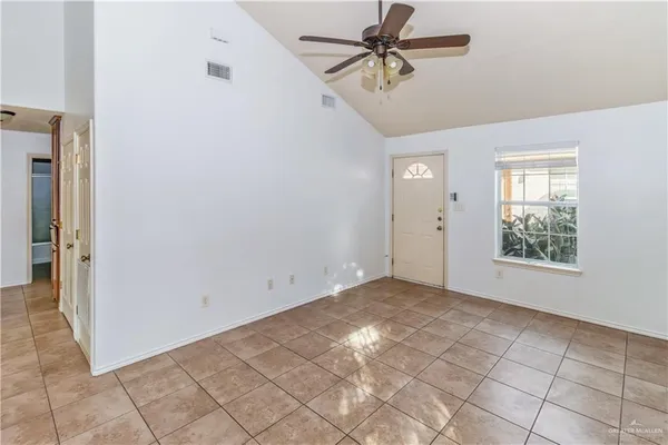 a view of room with hardwood floor and fan