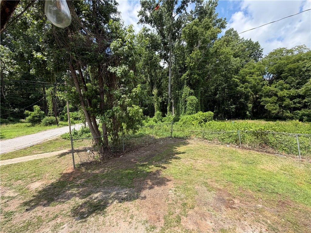302 Sirrine Street Honea Path, SC 29654 - Photo 23 of 24 A well-maintained lawn bordered by mature trees offers a tranquil, natural setting.