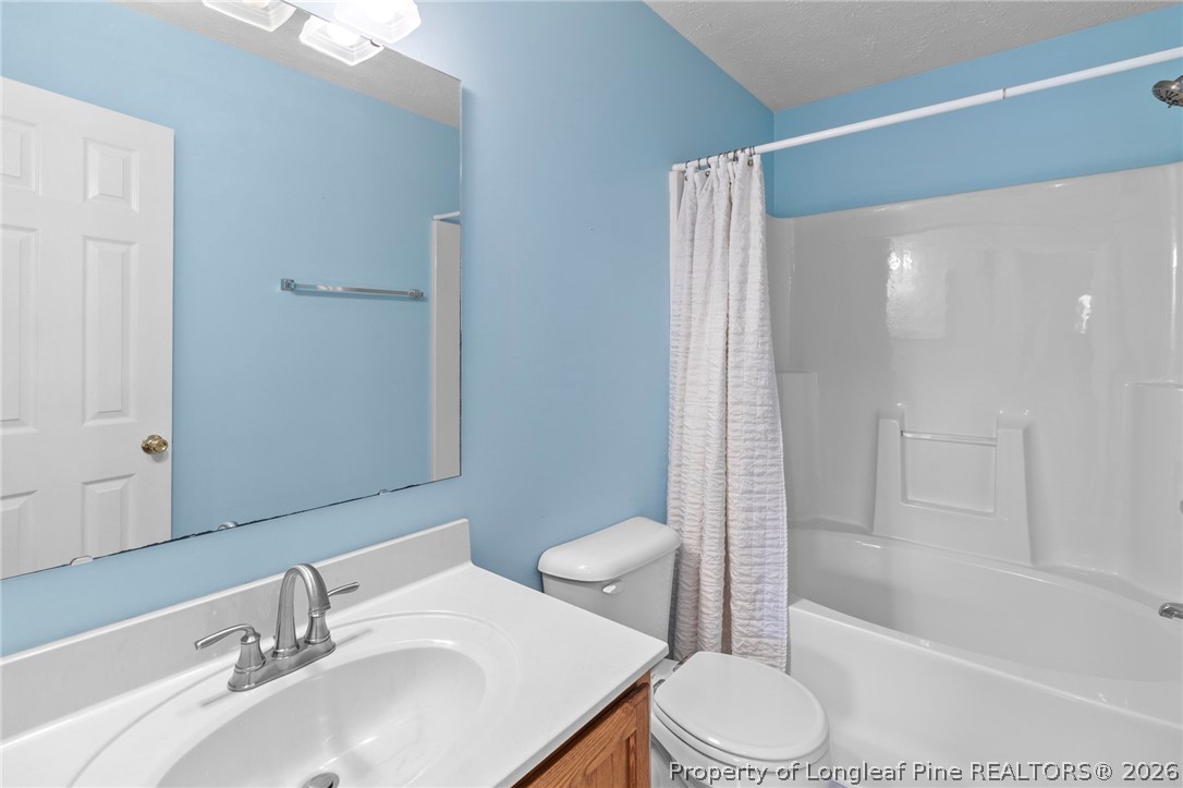28 Coyt Circle Spring Lake, NC 28390 - Photo 27 of 41 a bathroom with a sink toilet and shower