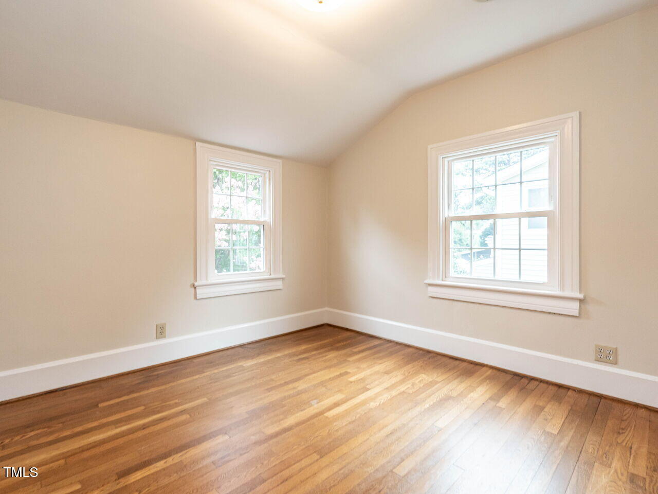 412 Morrison Avenue Raleigh, NC 27608 - Photo 20 of 26 a view of an empty room with wooden floor and a window